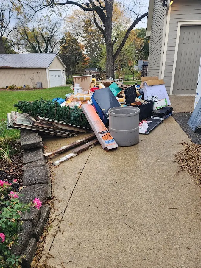 Dumpster being loaded with debris for 12 Yard Dumpster Rental in Bowdoinham